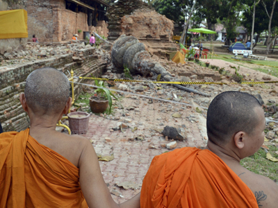 Dos monjes budistas observan los daños en el templo de Wat Chedi Luang (Tailandia)tras el seísmo de 6,8 grados.