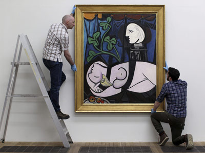 Dos operarios colocan la obra en la Tate Modern de Londres. EFE