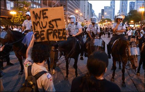 Um manifestante segura um sinal dizendo 'Nós temos que ser livre "enquanto protestavam contra a cimeira da NATO nas ruas de Chicago (EUA).  EPA / Tannen MAURY
