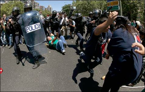 Varios manifestantes tratan de escapar en una de las cargas policiales en la Castellana - EFE
