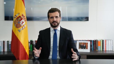 Instantánea facilitada por el Partido Popular de su presidente, Pablo Casado, en su despacho en la sede de Génova 13 junto a una fotografía con el rey Felipe VI.