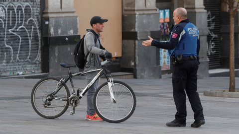 Un policía advierte a un ciclista durante el estado de alarma. Fuente: Efe