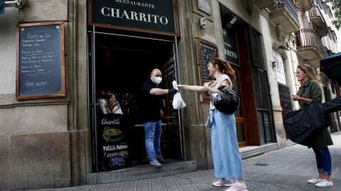 GRAFCAT5977. BARCELONA, 05/05/2020.- varias clientas recogen sus pedidos en un restaurante de Barcelona este martes cuando se cumplen 52 días de estado de alarma por la epidemia de coronavirus y segundo día de la fase 0 de desescalada. EFE/Quique Garcí