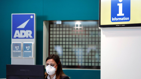 Una trabajadora del aeropuerto de Fiumicino en Roma se protege con una máscara después de que se confirmara el primer caso de coronavirus en Italia. REUTERS/Yara Nardi