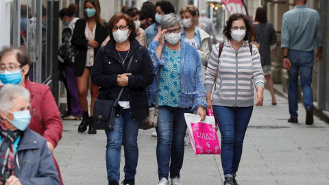 Varias personas con mascarilla caminan por la calle de Viviero, Lugo. EFE/ Eliseo Trigo