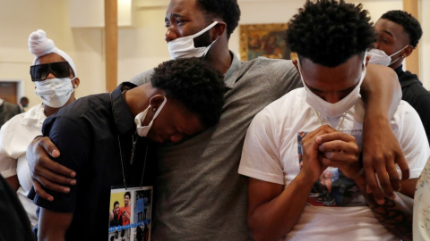 Unos hombres lloran en el funeral de Brandon Hendricks-Ellison, quien fue asesinado a tiros en el Bronx en Nueva York el 29 de junio. REUTERS / Shannon Stapleton