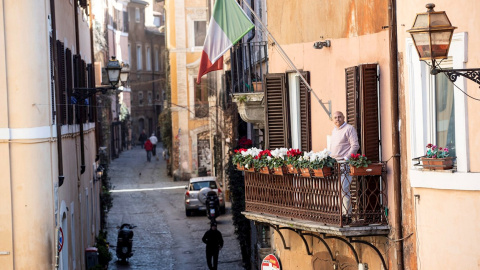 A man looking out onto the balcony of his house in the Trastevere district deserted due to the coronavirus outbreak in Rome, Italy 16 March 2020. Italy is under lockdown in an attempt to prevent the spread of the pandemic Coronavirus. Several European cou