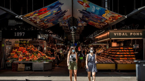 Dos visitantes salen del mercado de la Boquería de Barcelona este martes | EFE