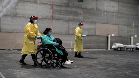 Una de las primeras pacientes llegando al recinto de Ifema habilitado como hospital por módulos | EFE