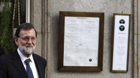 El presidente del Gobierno, Mariano Rajoy, a su salida de un restaurante en las inmediaciones del Congreso, horas después de fracasar en el pleno la moción de censura que presentó el grupo parlamentario Unidos Podemos contra él. EFE/Javier Lizón