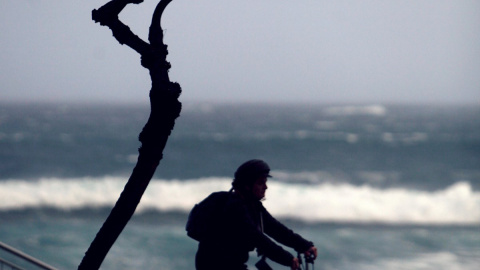 Una persona monta en bici este viernes por el paseo marítimo de la ciudad de A Coruña | EFE