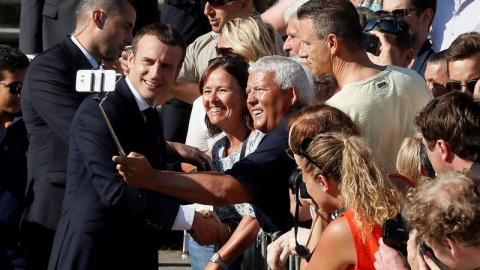 Emmanuel Macron se hace un selfi al llegar a su colegio electoral para votar en la segunda vuelta de las legislativas francesas. /EFE