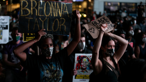 Gente con pancartas durante una marcha tras el anuncio de una sola acusación en el caso Breonna Taylor, en el distrito de Brooklyn de la ciudad de Nueva York. REUTERS / Jeenah Moon