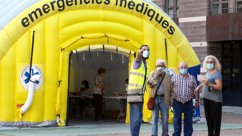 Varias personas acceden a la zona de realización de PCR durante el primer día de cribados masivos de Covid-19 en El Raval de Barcelona | EFE