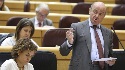 El ministro de Economía, Luis de Guindos, y la titular de Sanidad, Dolors Montserrat, durante la sesión de control al Gobierno en el pleno del Senado. EFE/Ballesteros