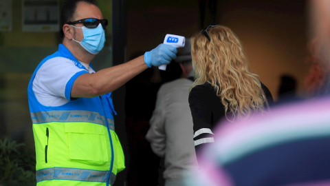 Un sanitario toma la temperatura a una mujer. EFE/Fernando Alvarado/Archivo