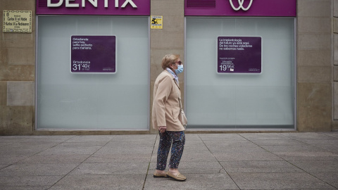 Una mujer paseas enfrente de una clínica Dentix en Pamplona. E.P./Eduardo Sanz