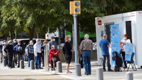 Varias personas hacen cola para vacunarse de la gripe en el Hospital del Mar de Barcelona este martes | EFE