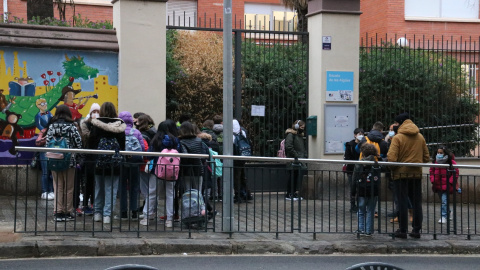 Pla general de l'Escola de les Aigües, amb pares i mares esperant alumnes.