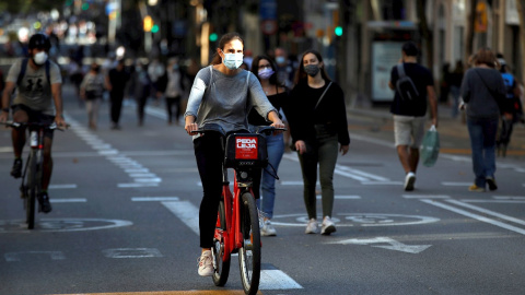 31/10/2020.- Vecinos del barrio de Sants de Barcelona, pasean por a Carretera de Sants cortada al tráfico.