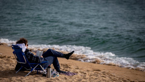 Una persona lee este miércoles en la playa de la Nova Icaria de Barcelona.