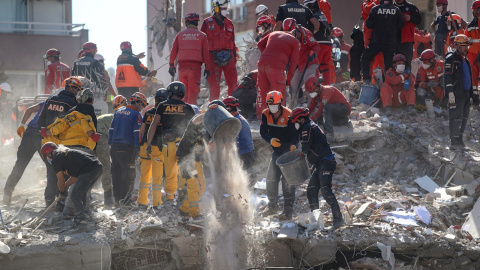 Trabajadores de rescate buscan sobrevivientes en un edificio derrumbado en el distrito de Bayrakli en Izmir, Turquía.