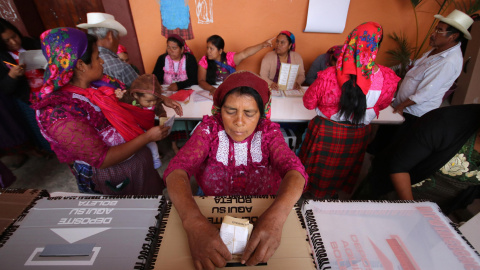 Una mujer deposita su voto en una colegio electoral de San Bartolomé de Quialana, México.- REUTERS/Jorge Luis Plata