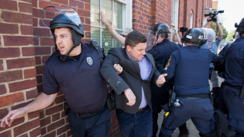 La policía escolta a Jason Kessler, organizador del mitin del grupo ultra 'Unite the Right'", después de una rueda de prensa en el Ayuntamiento de Charlottesville, Virginia. EFE / EPA / TASOS KATOPODIS