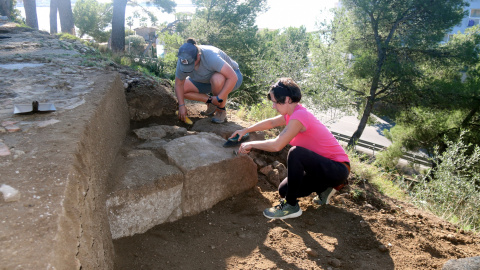 Les arqueòlogues netejant els fonaments de la torre del segle I aC que ha permès completar el dibuix de la façana de la vil·la romana del Collet