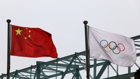 La bandera nacional china ondea junto a una bandera olímpica en el Comité Organizador de los Juegos Olímpicos y Paralímpicos de Invierno de 2022 en Beijing.