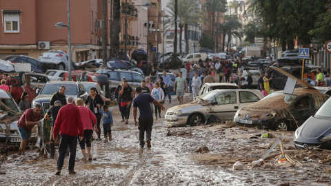 Varias personas caminan por una de las calles afectadas en Paiporta (València), tras las fuertes lluvias causadas por la DANA, a 30 de octubre de 2024.