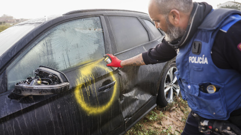 Agentes de la Policía de Madrid revisan vehículos y marcan con un 0 revisados sin víctimas en su interior y con una V en caso de encontrar víctimas en València, a 6 de noviembre de 2024.