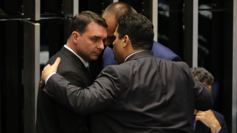 26/12/2020. El senador Flávio Bolsonaro, junto al presidente del Senado, Davi Alcolumbre (de espaldas), y su hermano el diputado federal Eduardo Bolsonaro. - Agência Brasil