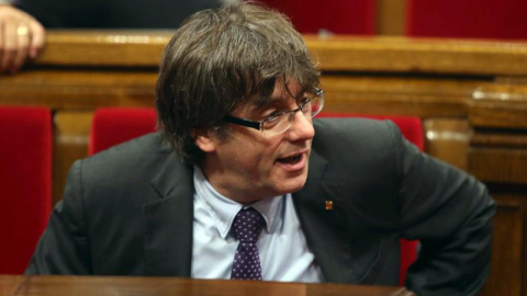 El presidente de la Generalitat, Carles Puigdemont, abandona el hemiciclo tras volver a suspenderse el pleno por una nueva petición para reunir de nuevo a la Mesa y Junta de Portavoces, tras solicitud de Junts pel Sí y de la Cup de la alteración del or