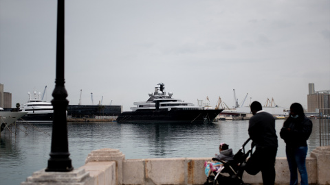 Varias personas delante de un yate retenido en el puerto de Tarragona, a 17 de marzo de 2022.