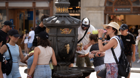 18/07/2023 - Varias personas se refrescan y rellenan sus botellas de agua en la fuente de Canaletas, a 18 de julio de 2023, en Barcelona, Catalunya.