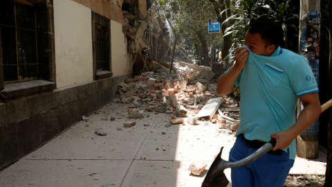 Un hombre se tapa la cara junto a un edificio derruido tras el terremoto en Ciudad de México. - REUTERS