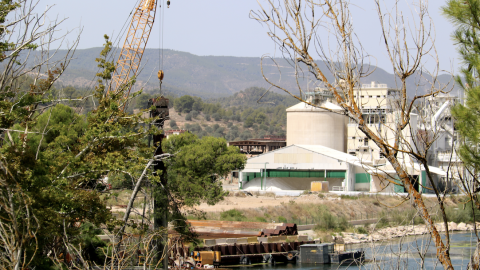 11-8-2023 Les grues fent els últims treballs de desmuntatge del recinte de descontaminació al pantà de Flix, davant del complex químic