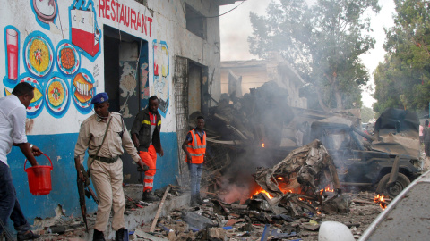 Policías somalíes investigan uno de los coches bomba que han sido detonados en la capital de Somalia. REUTERS/Feisal Omar