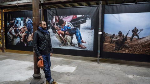 El fotoperiodista Manu Brabo posa ante varias de sus obras que forman parte de "Un día cualquiera", una muestra que junto a National Geographic, ha inaugurado hoy en el centro cultural La Neomudéjar, en Madrid. EFE/Emilio Naranjo