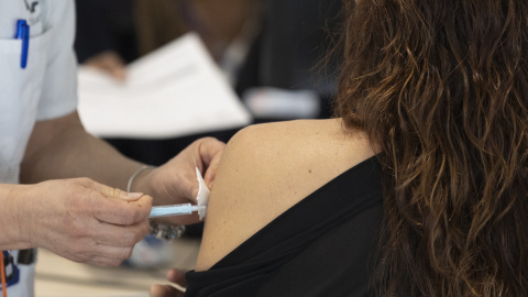 Una mujer recibe la tercera dosis de la vacuna contra el covid, en el Hospital Enfermera Isabel Zendal, a 13 de enero de 2022, en Madrid.