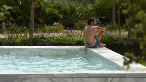 Un hombre en el borde de una piscina de València, a 12 de agosto de 2021.