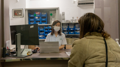 Una trabajadora del Hospital Clínic de Barcelona atiende a una paciente en el punto de consulta.