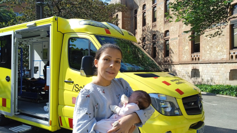 La pequeña Aisha y su madre frente a una ambulancia en las inmediaciones del Hospital Vall d'Hebron de Barcelona.