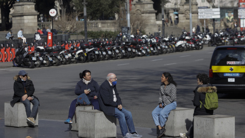 Unas personas descansan y hablan en el centro de Barcelona, a 10 de febrero de 2022.