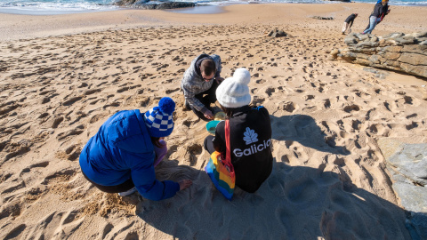 8/1/24 Varias personas limpian de pellets la playa Do Vilar, en Ribeira (A Coruña), el pasado domingo.