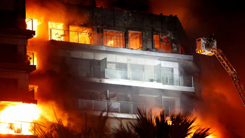 Firefighters work at the scene of a fire of apartment building in Valencia, Spain