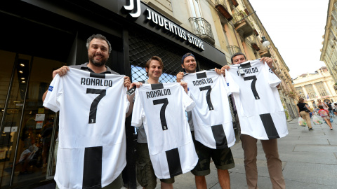 Varios hinchas de la Juventus posan con la camiseta del equipo con el nombre y el número de Ronaldo tras confirmarse su traspaso. /REUTERS