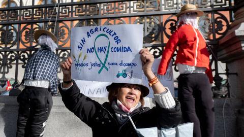 Una mujer con un cartel en el que se lee: 'Sin agricultor no hay comida' durante una concentración de agricultores y exportadores de naranjas, frente al Ministerio de Agricultura, a 24 de noviembre de 2021, en Madrid, (España).