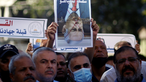 Un manifestante palestino sostiene una imagen tachada de Benjamin Netanyahu, durante una protesta por una marcha de grupos israelíes de extrema derecha en la Ciudad Vieja de Jerusalén. REUTERS / Mohammed Salem